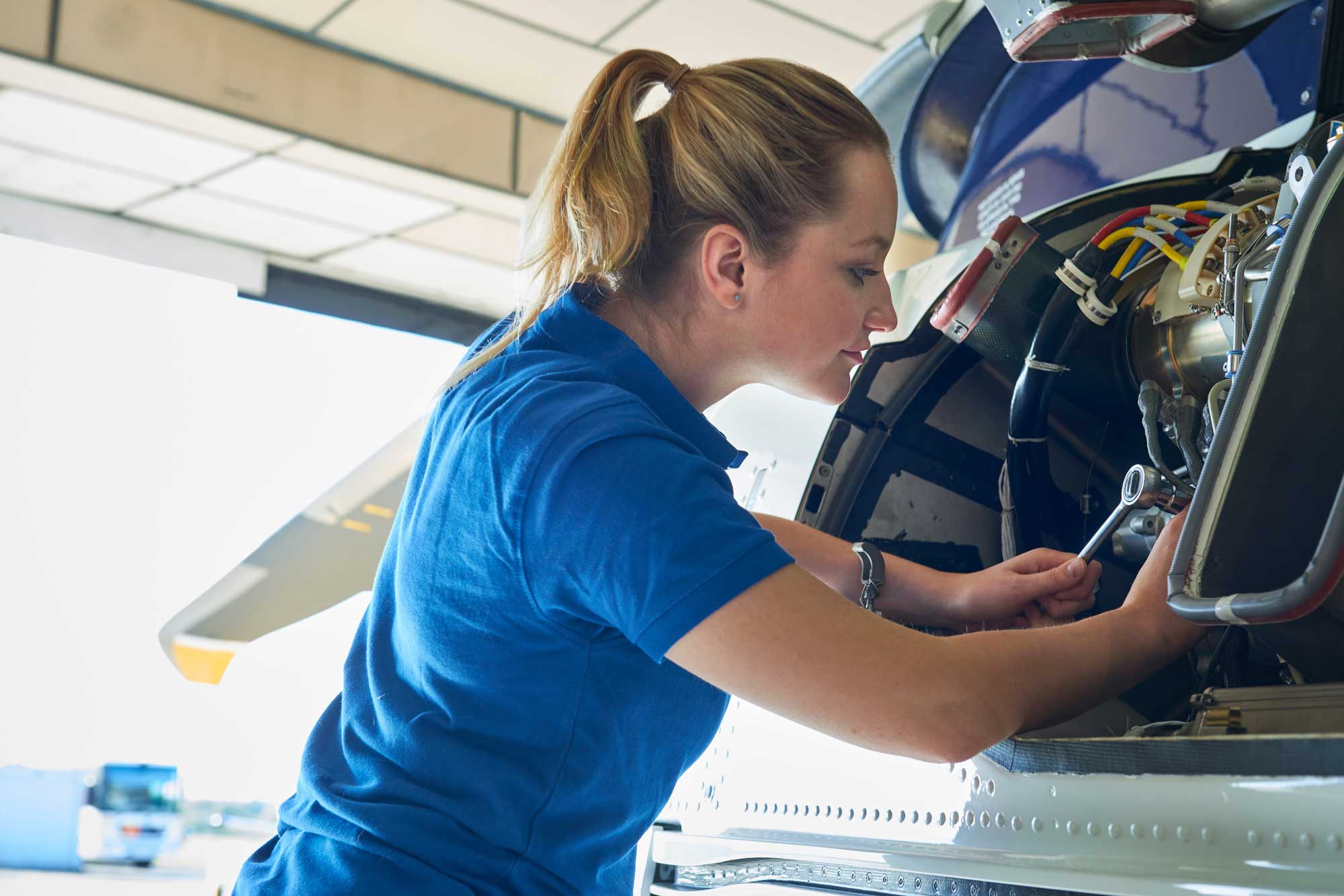 Woman working on aircraft