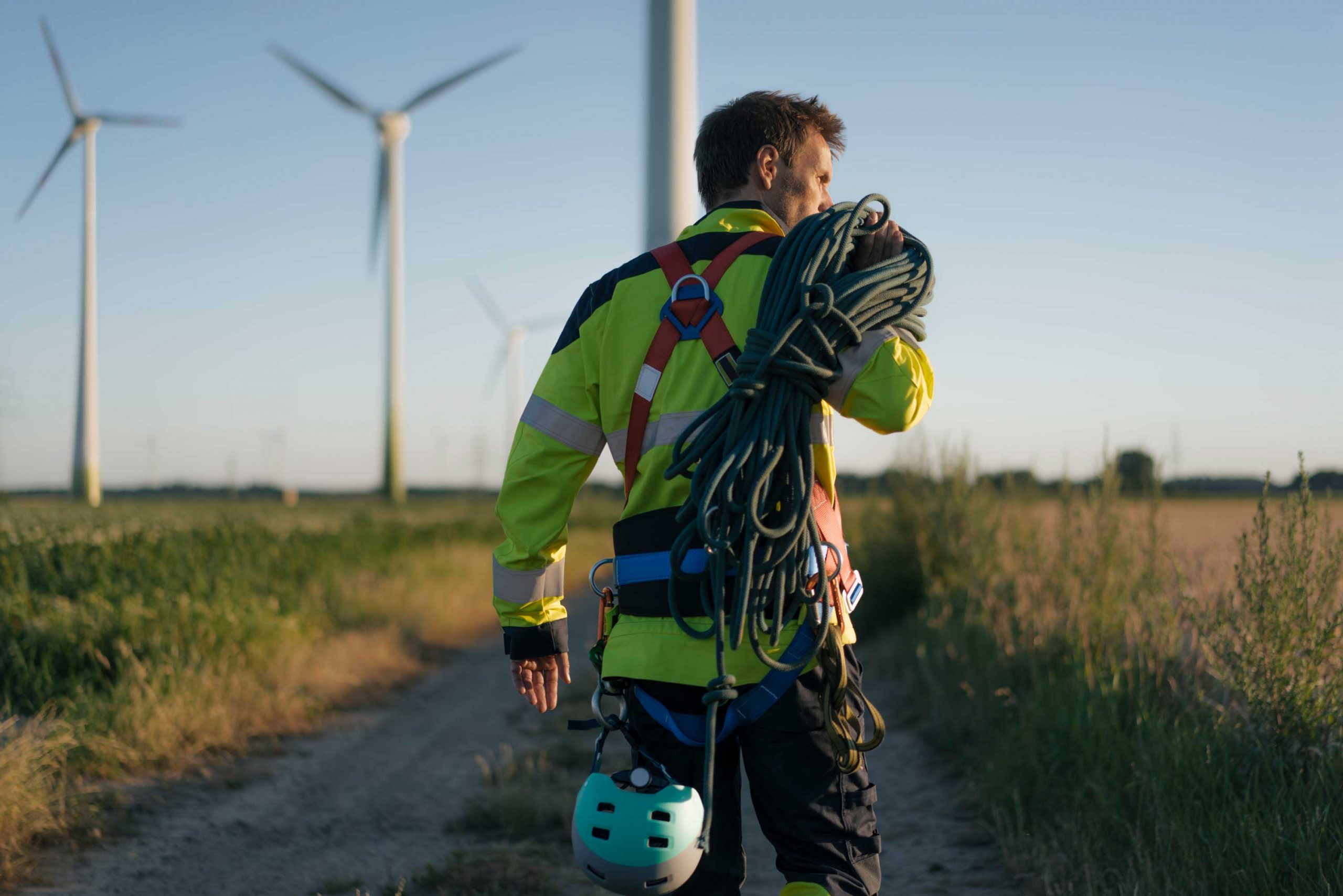 Man on wind turbine farm