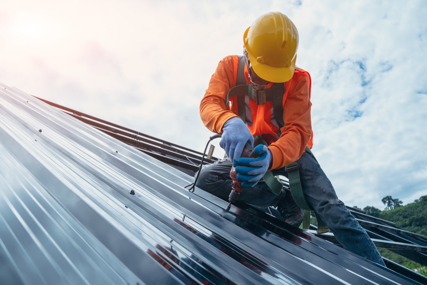 Roofer worker in special protective work wear and gloves