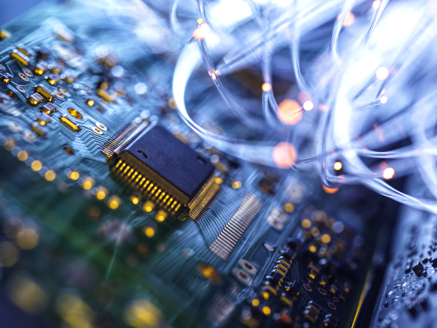 Fibre optics carrying data passing through electronic circuit boards, close up technology