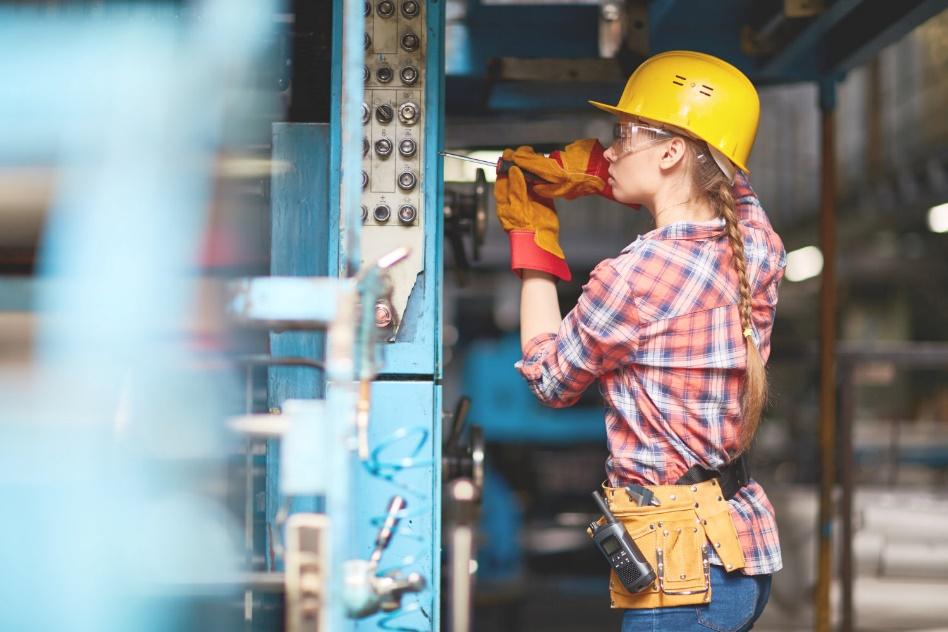 Women performing maintenance on machinery