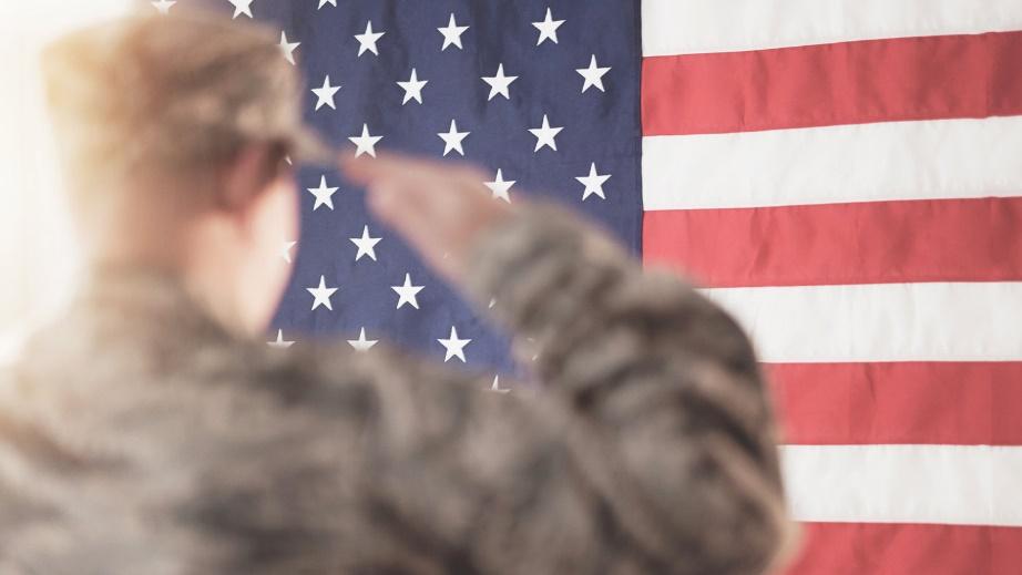 Solider saluting American flag