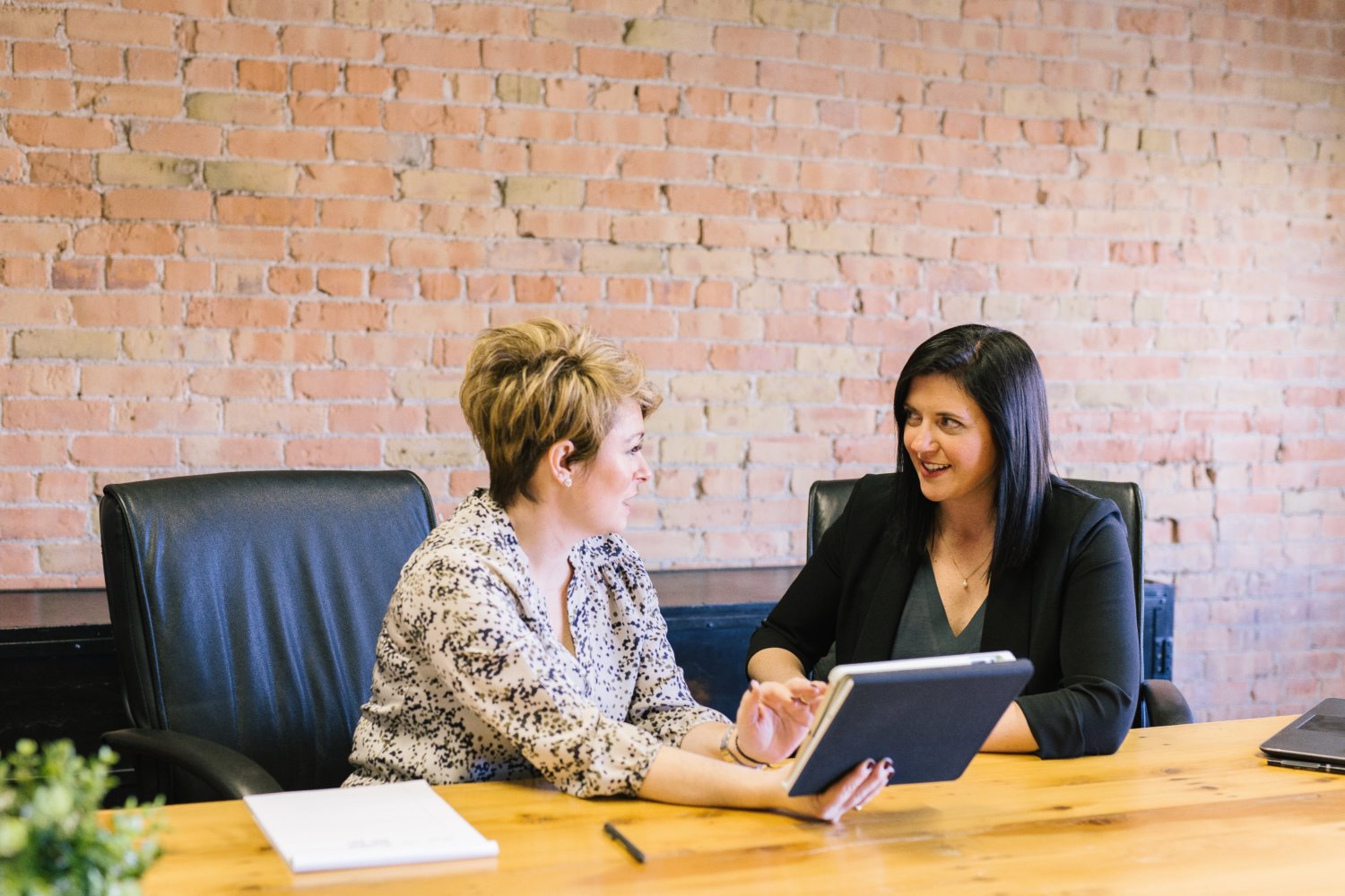 Women at desk talking