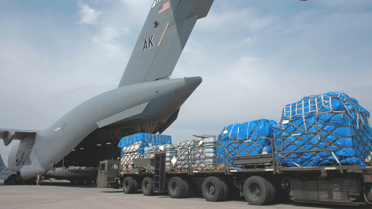 Items being loaded on cargo military plane