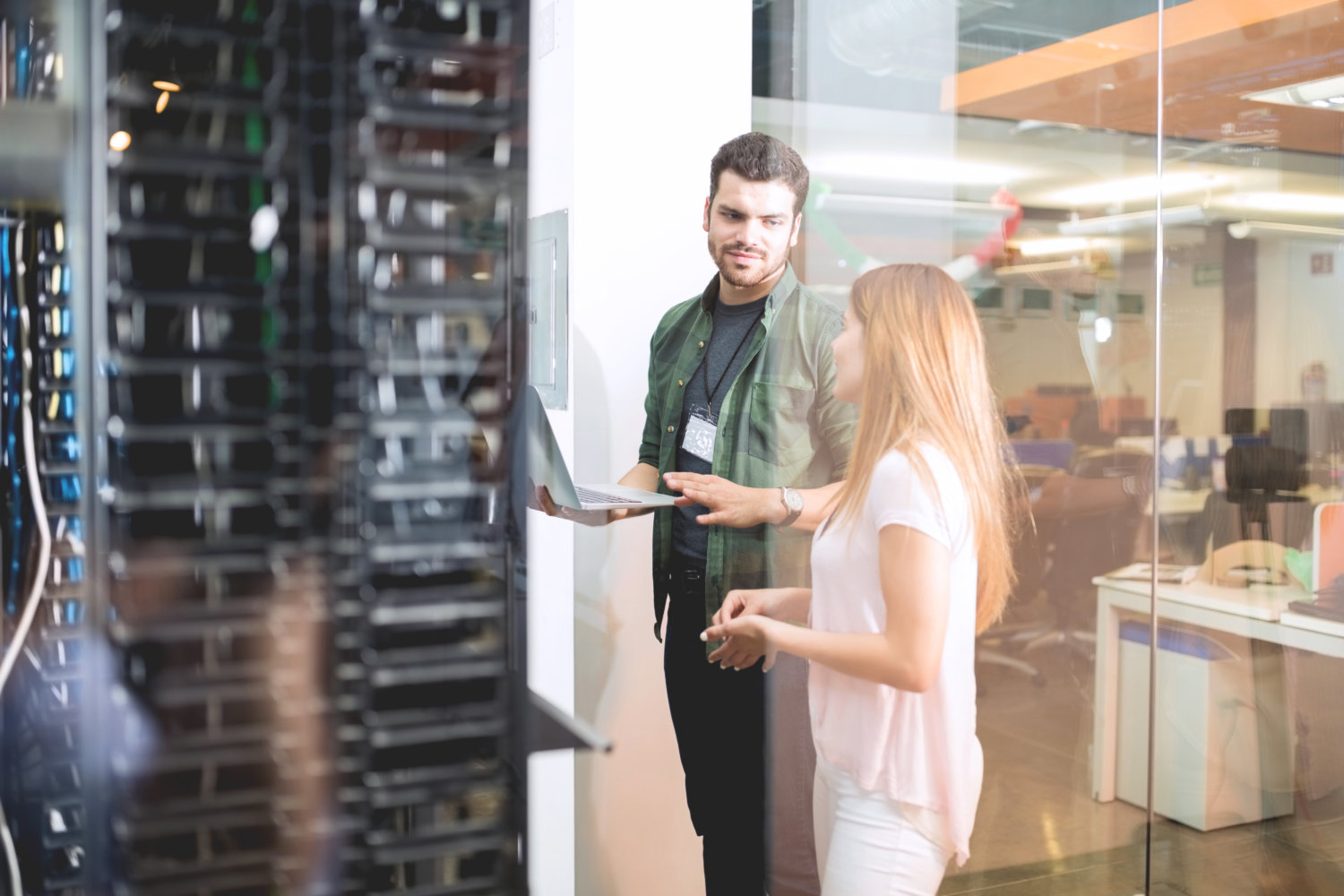 Colleagues discussing in office server room