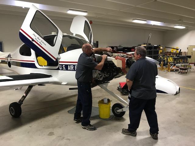 Men working on U.S. Air Force tow aircraft