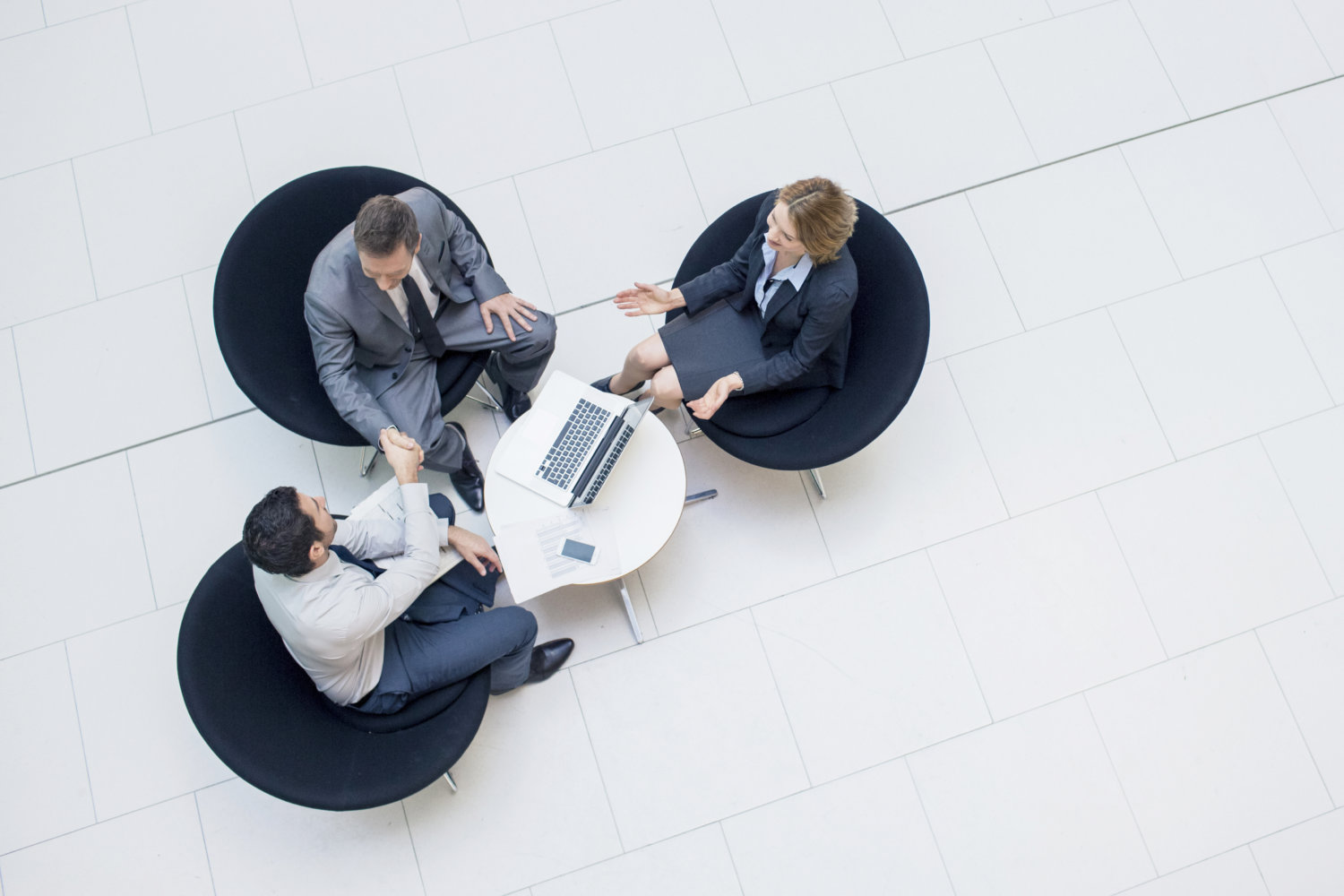 Three business people sealing a business deal